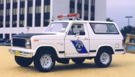 1979 Ford Bronco - This white SUV, likely a 1978 model, is equipped with emergency lights and a distinctive side decal.