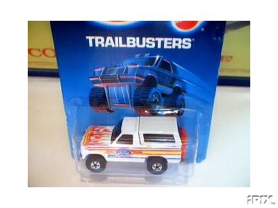 1979 Ford Bronco - A white toy truck with flame decals and a camper shell is displayed in its original packaging.