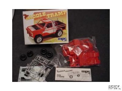 1979 Ford Bronco - This MPC 'Saddle Tramp' model kit box is shown with its unassembled parts, including red plastic components and tires.