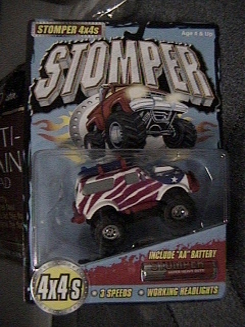 1979 Ford Bronco - This toy truck, packaged for retail, features a patriotic red, white, and blue flag design.