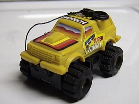 1979 Ford Bronco - This toy truck features oversized tires and "Super Winch" branding on its sides and roof.