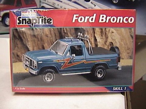 1979 Ford Bronco - Photo of a Monogram SnapTite "Ford Bronco" 1/32 scale Skill 1 model kit box, with box art of a blue open-top Bronco wearing orange and red…