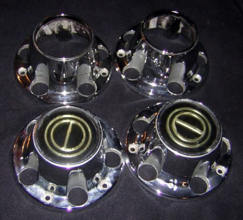 1995 Ford Bronco - A set of four chrome hubcaps, likely for a truck or SUV, are displayed against a dark background.