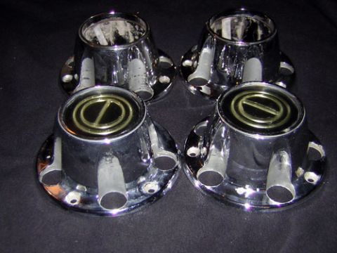 1995 Ford Bronco - A set of four chrome hubcaps are displayed against a dark background.