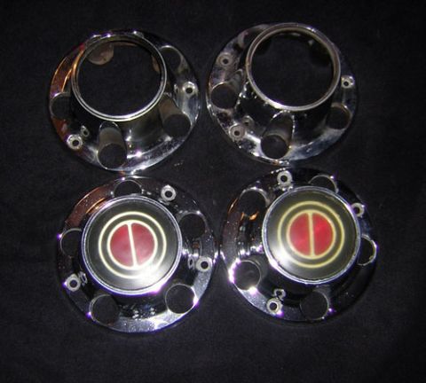 1995 Ford Bronco - Set of four chrome hubcaps, each a red and yellow circular emblem, likely for a truck or SUV.