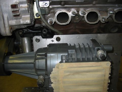 1993 Ford Taurus - Close-up view of engine components including an alternator and a supercharger assembly.