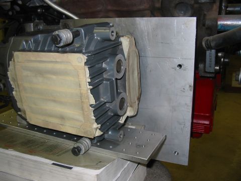 1993 Ford Taurus - Close-up of an engine part secured to a metal plate, possibly for testing or repair.