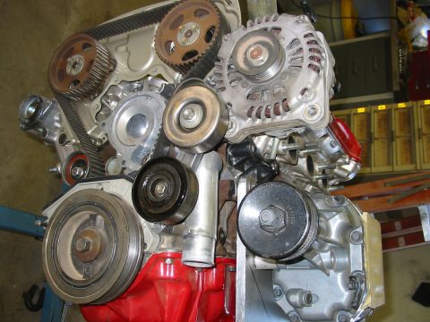 1993 Ford Taurus - Close-up view of an engine assembly, showing various mechanical components and a red engine block.