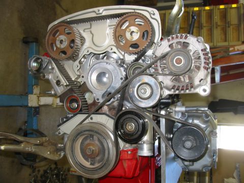1993 Ford Taurus - Close-up view of an engine's timing belt and accessory drive system components.