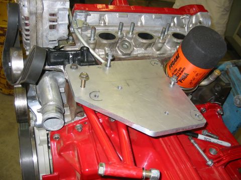 1993 Ford Taurus - A close-up view of an engine component with a FRAM PH8A oil filter mounted on an aluminum plate.