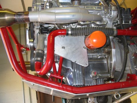 1993 Ford Taurus - Engine part with an orange oil filter and red tubing, possibly from a custom build.