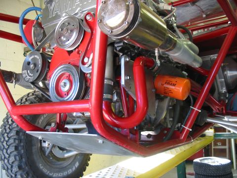 1993 Ford Taurus - The engine bay of a custom off-road vehicle features a Yamaha engine and bright red tubing.