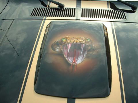 1978 Ford Mustang II - Custom airbrushed snake art adorns the hood of this 1978 Ford Mustang II, accented by dual racing stripes.