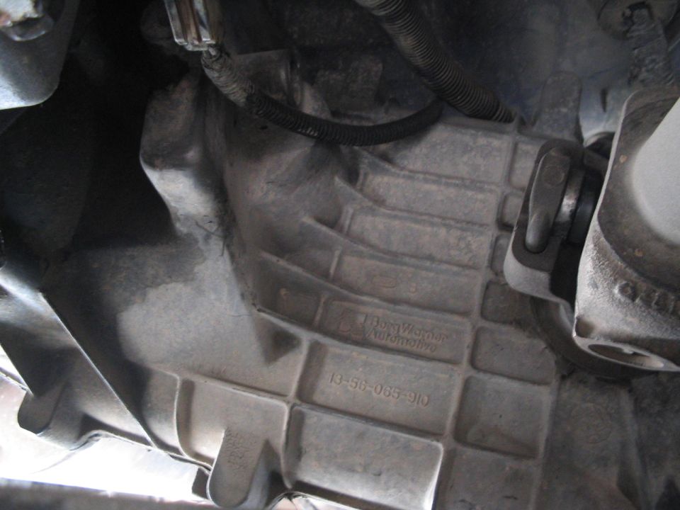 Transmission housing with BorgWarner Automotive text and part number 13-56-065-910