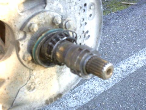 1995 Ford Bronco - Close-up view of a vehicle's wheel hub and axle assembly, with visible splines on the axle shaft.