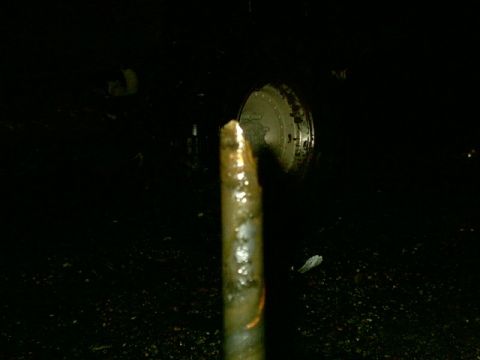 1995 Ford Bronco - A close-up view of a metal rod and a circular component, with visible text at the bottom right.
