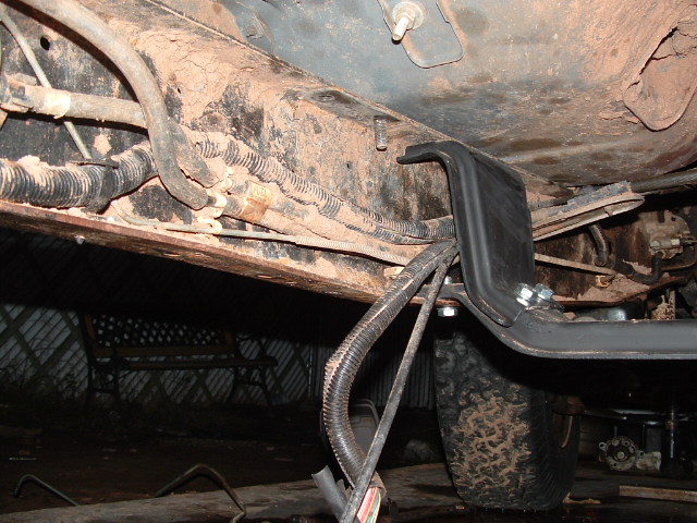 Underbody view of a vehicle frame, fuel tank skid and wiring harness