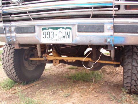 1985 Ford Bronco - Close-up view of the front suspension and bumper assembly, a Colorado license plate.