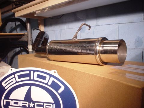 1993 Ford Taurus - A Magnaflow exhaust muffler is displayed on a cardboard box, with a Scion NorCal sticker visible in the foreground.