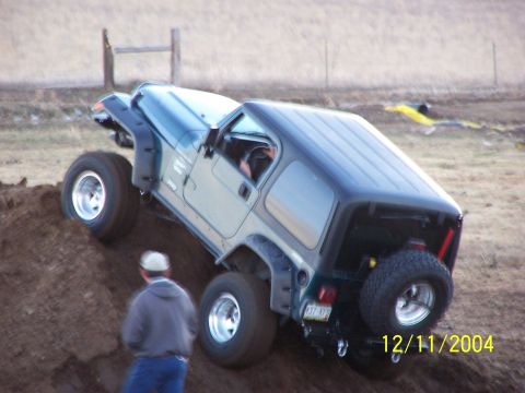 1985 Ford Bronco - Jeep Wrangler tackling an off-road obstacle, captured on December 11, 2004.