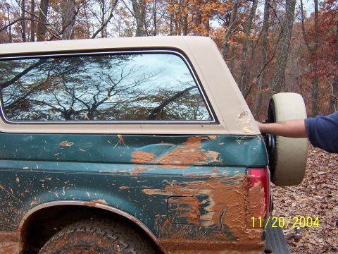 1978 Ford Bronco - This heavily mud-splattered SUV is seen from the rear, with a spare tire mounted externally. A date watermark indicates it was photographed…