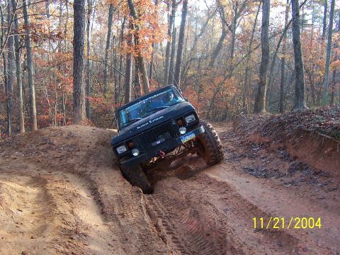 1978 Ford Bronco - 1978 Ford Bronco tackling an off-road trail during autumn.