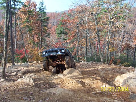 1978 Ford Bronco - This 1978 Ford Bronco is tackling a challenging rocky path in the woods.