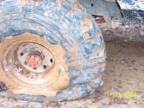 1978 Ford Bronco - A close-up view of a mud-splattered tire and wheel, with the date 11/21/2004 visible in the lower right corner.