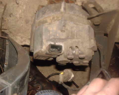 1985 Ford F-150 - Close-up view of an alternator, likely from a vehicle's engine bay.
