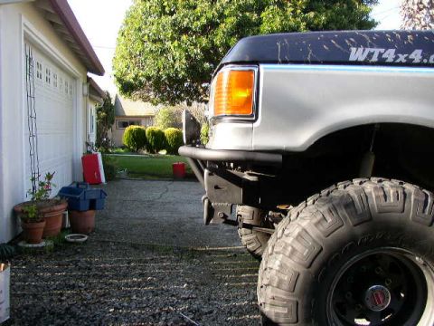 1989 Ford Bronco - Close-up of a large off-road tire and front bumper on a Ford truck.