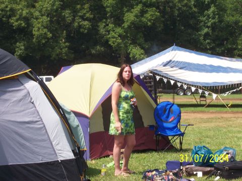 1979 Ford F-150 - A woman stands near tents at a campsite, with a date stamp of 31/07/2004 visible in the foreground.