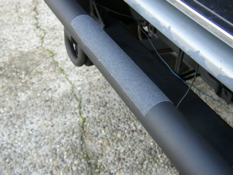 1989 Ford Bronco - Close-up of a vehicle's aftermarket step bar, grip tape for traction. Supermotors logo is visible.