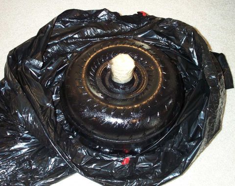 1998 Ford Crown Victoria - A black torque converter is shown wrapped in a black plastic bag, likely for shipping or storage.