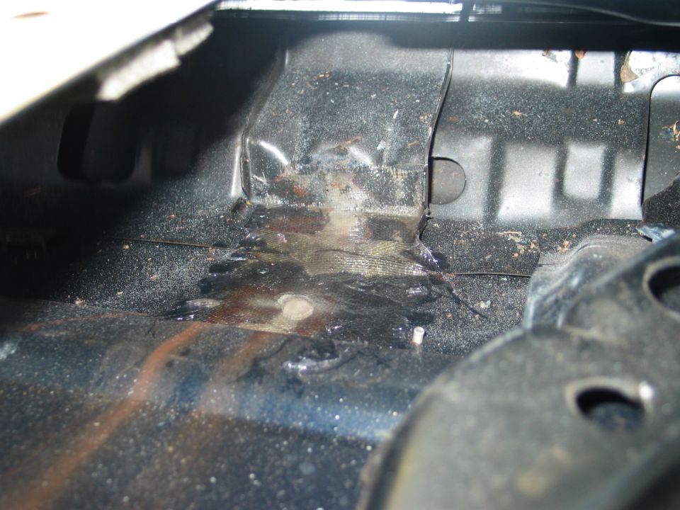 Rusted and water-stained vehicle floor pan interior sheet metal