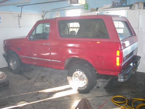 1995 Ford Bronco - Red 1995 Ford Bronco in a garage with the door open.