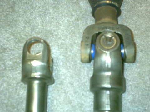 1995 Ford Bronco - Close-up of two steering shaft components, one with "SPICER" branding visible.