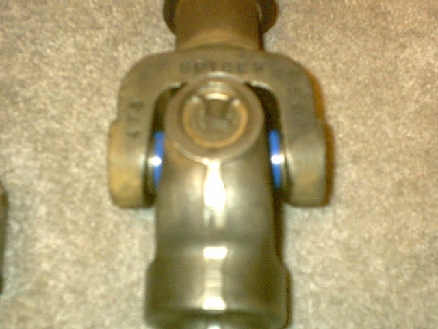 Spicer driveshaft U-joint and slip yoke close-up on carpet