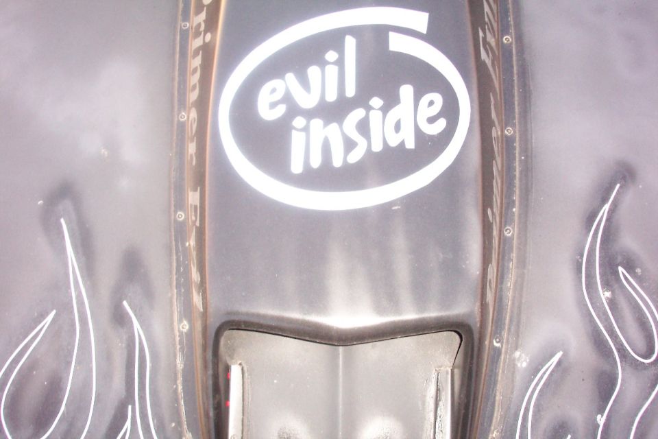 Black primer hood scoop with white 'evil inside' Intel-style decal and pinstriped flames