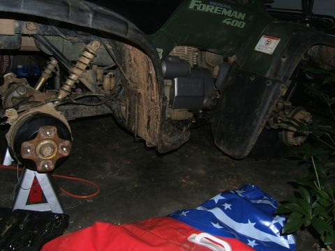 1978 Ford Bronco - A green Honda Foreman 400 ATV is shown with its front wheel removed and supported by a jack.