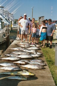 2003 Jeep TJ - A group of people stand behind a large catch of fish displayed on a wooden dock.
