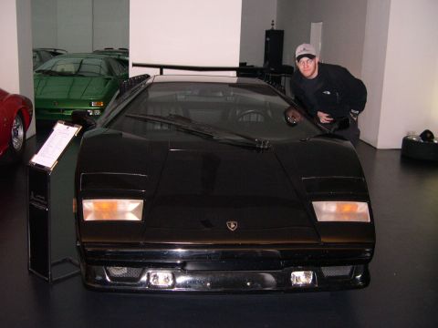 2003 Jeep TJ - A black Lamborghini Countach is displayed with other cars in the background.