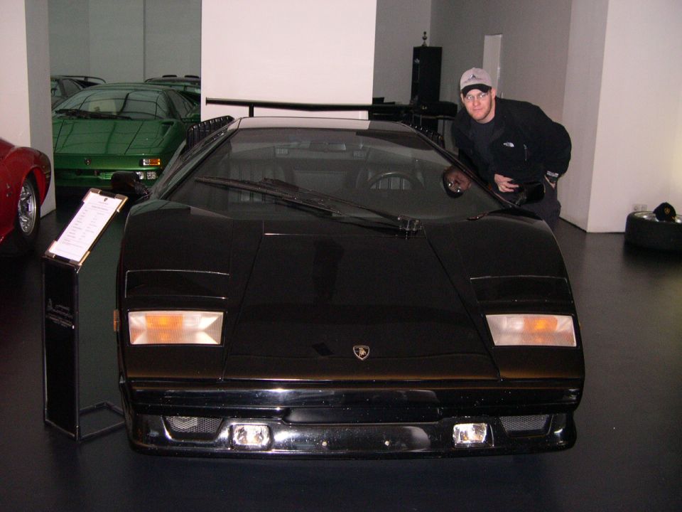 Black Lamborghini Countach front view with a man to the right