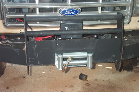 1987 Ford Bronco - A Ford truck's front end is shown with a newly installed winch and bull bar, with visible "T-MAX" branding.