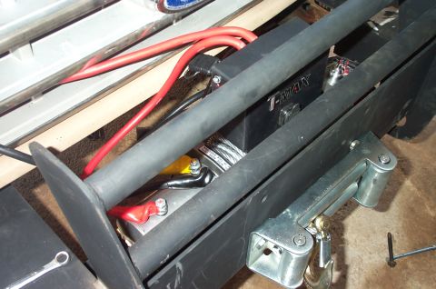 1987 Ford Bronco - Close-up view of a winch and bumper assembly, T-MAX branding and red electrical cables.
