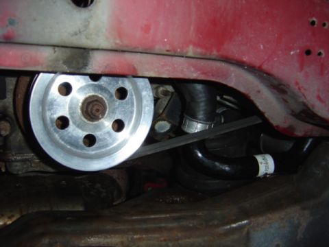 1998 Ford Taurus - Close-up view of an engine pulley and belt system, with visible hoses and metal components.