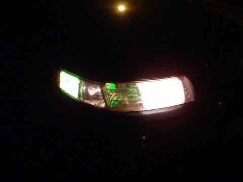 1993 Ford Taurus - Illuminated front passenger side headlight and turn signal of a 1993 Ford Taurus.