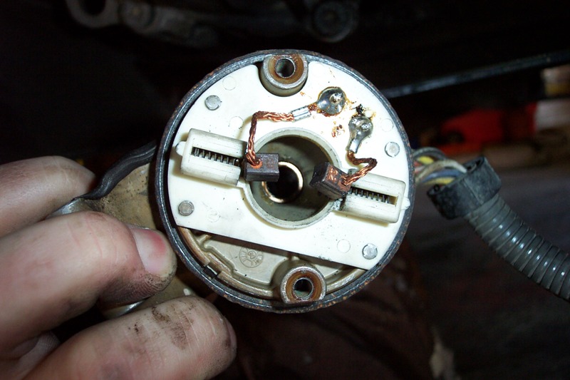 Here are the brushes and springs I was talking about.  When reinstalling the motor, keep these pushed in with a pick or small screwdriver, then slip the arbor in.  Rotate it counter-clockwise to screw it in until it's all the way in.