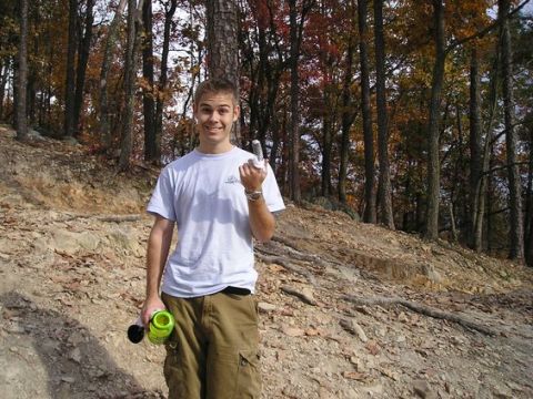 1993 Ford Bronco - A young man poses in a wooded area with autumn foliage, holding a water bottle and a remote control.