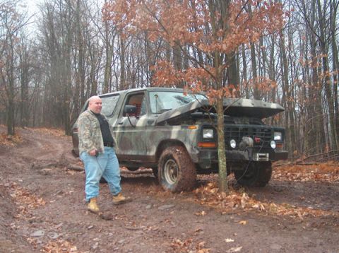 1993 Ford Bronco - Man and his 1978 Ford Bronco are stuck in the mud on a forest trail.