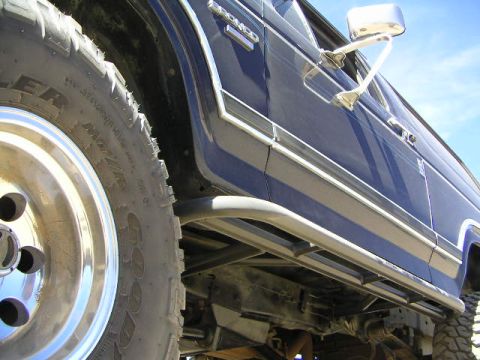 1985 Ford Bronco - This Ford Bronco features off-road tires and side steps, suggesting it is modified for terrain.
